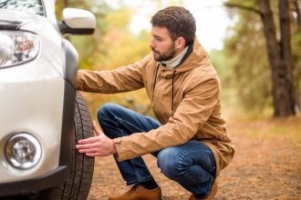 Checking tyres before a car road trip