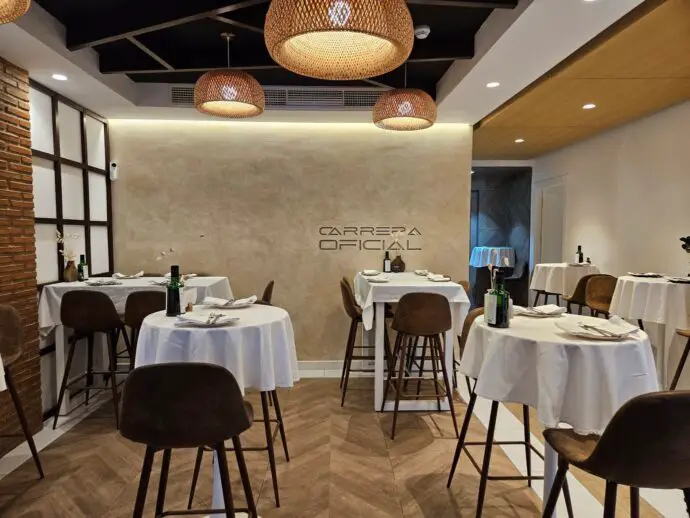 Restaurant with tall tables covered in white cloths