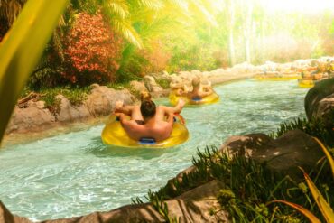 People floating down a river in yellow inflatable tubes