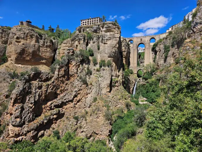 Gorge with stone bridge across and waterfall below