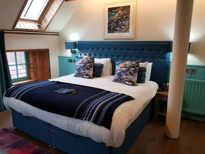 Bed in bedroom with a skylight overhead