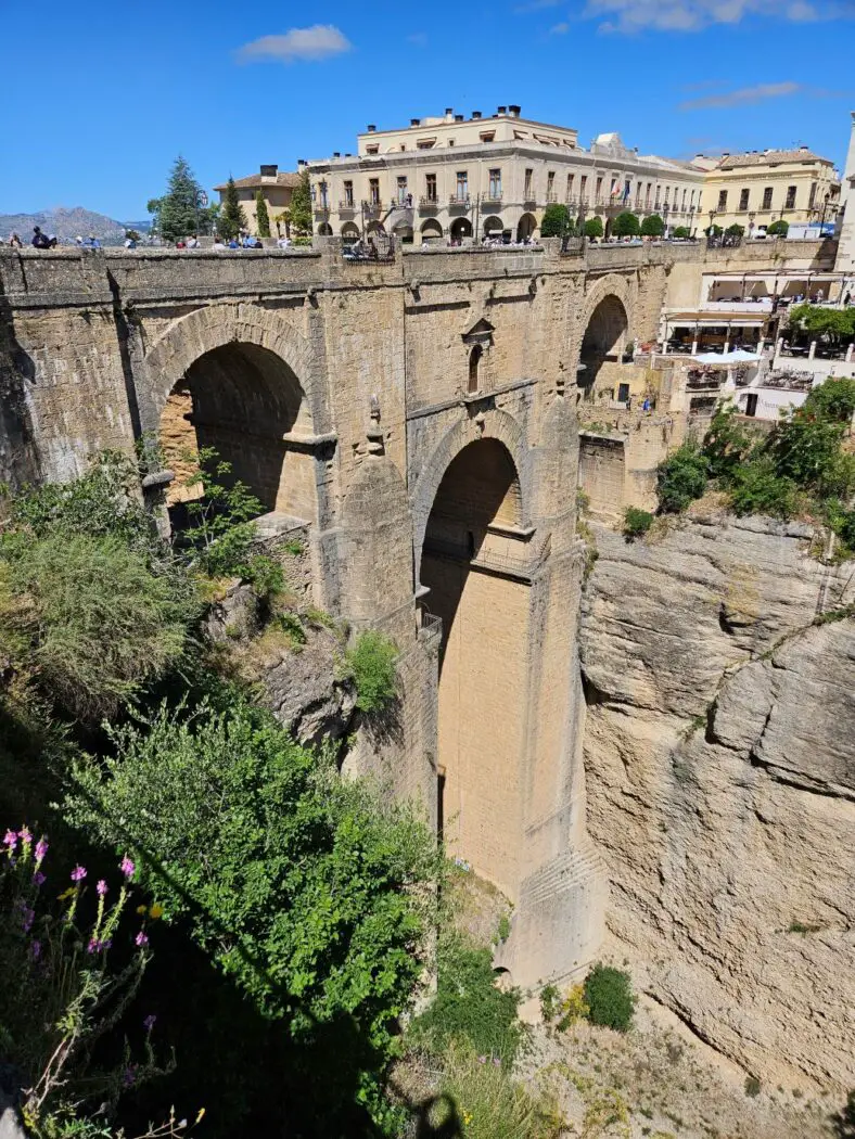 Close up view of a large stone bridge across a rocky gorge