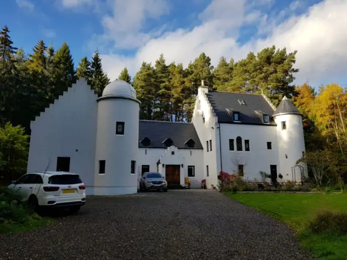 White castle building surrounded by trees