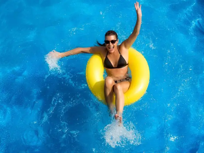 Woman floating in a swimming pool